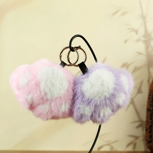 Vue détaillée de porte-clés patte de chat en peluche rose et violet avec anneaux dorés