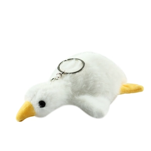 Cute white plush goose keychain with yellow beak and feet on white background