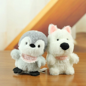 Detail of plush penguin and puppy keychains wearing pink checkered lace bibs