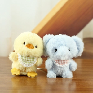 Detailed plush keychain charms of a fluffy yellow chick and blue elephant with lace bibs