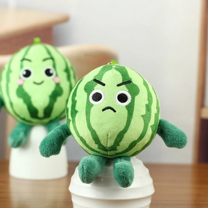 Detail of cute watermelon plush keychains with embroidered facial expressions on display