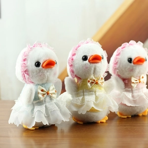 Detailed plush duck dolls in lace dresses and plaid hats on a rustic wooden table