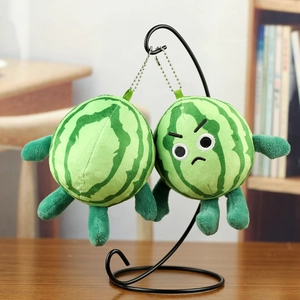 Detail of cute watermelon plush keychain with embroidered expressions and silver chain