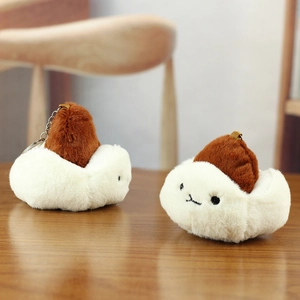 Close-up of cute plush bun keychain charms with fluffy fur and silver metal chain