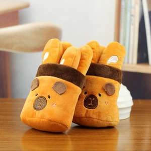 Close-up of cute plush capybara charms featuring soft orange fabric and detailed embroidery