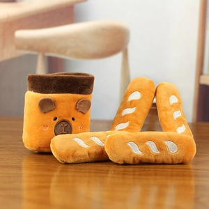 Detail of plush brown bag with cute bear embroidery and soft stuffed baguette toys