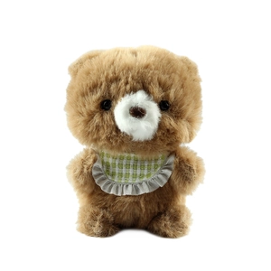 Cute brown plush bear keychain with green checkered bib on white background