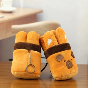 Detail of plush orange capybara charms featuring cute animal faces and metal keyrings