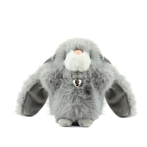 Cute gray plush bunny pendant with soft long faux fur and silver heart charm on white background