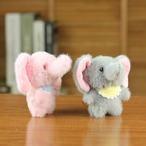 Close-up of plush elephant dolls in pink and grey colors with soft fluffy texture