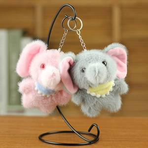 Detail of plush elephant keychains in pink and grey with soft fur and metal rings