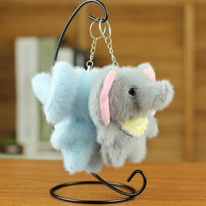 Detailed view of blue and grey plush elephant keychains hanging on a minimalist black stand