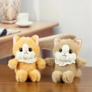 Cute golden and grey cat plush toys with lace collars in a cozy home setting