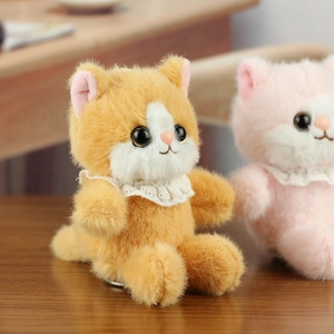 Detail of plush cat toys with fluffy golden velvet fabric and white lace collars