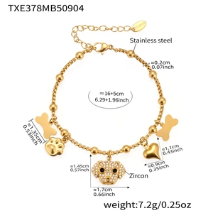 Detailed view of gold stainless steel bracelet with zircon puppy and bone charms