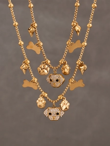Close-up of gold-plated dog pendant necklace with sparkling cubic zirconia charms