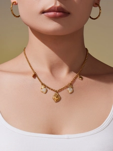 Ensemble collier doré avec pendentifs en forme de cœur porté par un mannequin femme