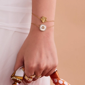 Ensemble collier fleur en acier doré et bagues léopard sur un mannequin femme