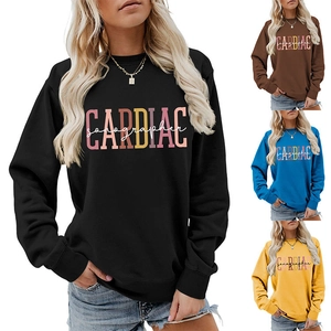 Close-up of long sleeve sweatshirts in black, brown, blue and yellow with cardiac print