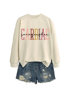 Detail of Cardiac Sonographer print on cream crewneck sweatshirt with casual denim