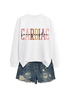 Detail of Cardiac Sonographer print on white sweatshirt with distressed denim shorts