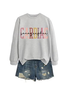 Detail of Cardiac Sonographer print on grey sweatshirt paired with blue denim shorts