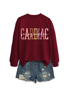 Detail of burgundy CARDIAC sonographer sweatshirt with distressed blue denim shorts