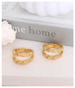 Detailed macro view of 18K gold-plated double-layered rings with hammer-textured lava finish