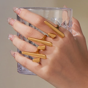 Three-piece set of gold geometric open rings featuring avant-garde linear design elements