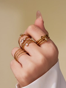 Detail view of 18k gold-plated nail ring set with sparkling zirconia on human hand