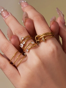 Detailed close-up of 18k gold plated stacking rings set with sparkling 5A zircon stones