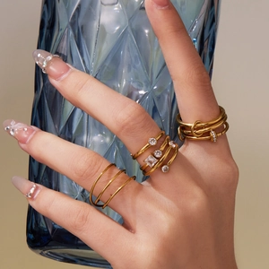 Golden 18k plated stackable ring set featuring 5A zircons and a nail design accent