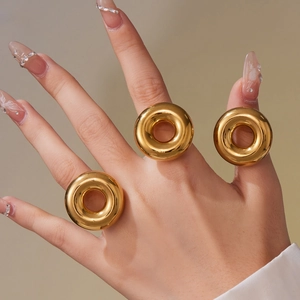 Three-piece set of thick golden donut rings with a mirror-polished stainless steel finish