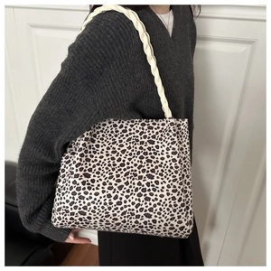 Detail of leopard print canvas tote bag featuring a thick woven shoulder strap for women