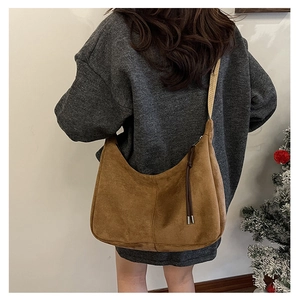 Winter vintage brown suede half-moon crossbody bag with tassel and woven shoulder strap