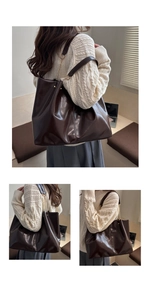 Detailed view of the dark brown glossy leather tote bag with stylish chain shoulder strap