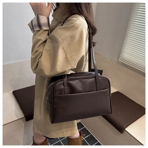 Detail view of large dark brown leather tote bag with vintage texture and long straps