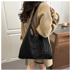 Close-up of leopard print tote bag with soft texture and wide shoulder strap