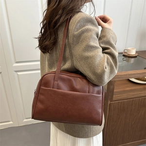 Minimalist vintage dark brown leather tote bag shown from a 45-degree back angle