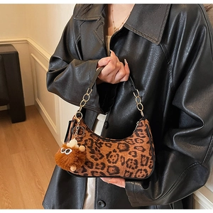 Detail of leopard print crescent bag with black leather strap and gold chain