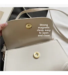 Detail of strong magnetic clasp and clean stitching on a vintage beige crossbody bag