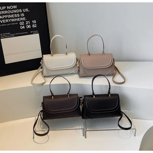 Minimalist crossbody handbags shown in four colors with smooth leather and metal buckles