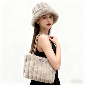Close-up of beige faux fur bucket hat and tote bag set with vertical stripe texture