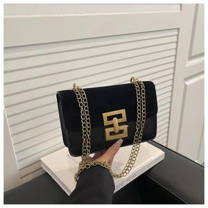 Detail of trendy black crossbody bag with suede-leather mix and golden buckle