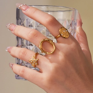 Three-piece gold star and geometric open rings set with sparkling zircon stones