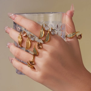 Gold-tone adjustable ring set with teardrop zircon and light blue enamel accents