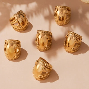 Set of six chunky gold-plated stainless steel dome rings with vintage floral engravings