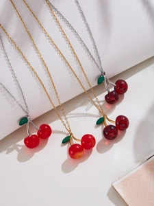 Detailed view of cherry pendant necklaces with translucent red resin and metal chains