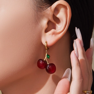 Chic gold cherry earrings with translucent red resin drops and green leaf detail