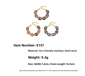 Polished 18k gold plated stainless steel bracelet with amber resin links and lobster clasp